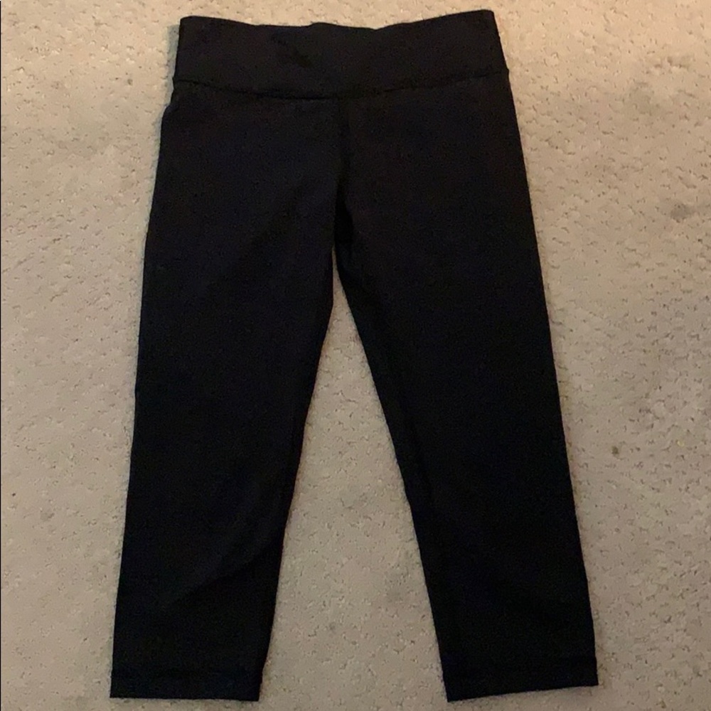 Black Ivivva leggings and a colorful sports bra